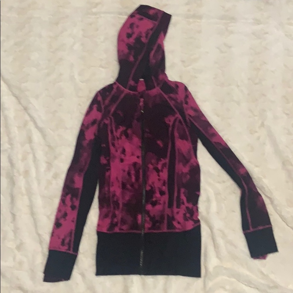A black and pink zip-up Lululemon jacket